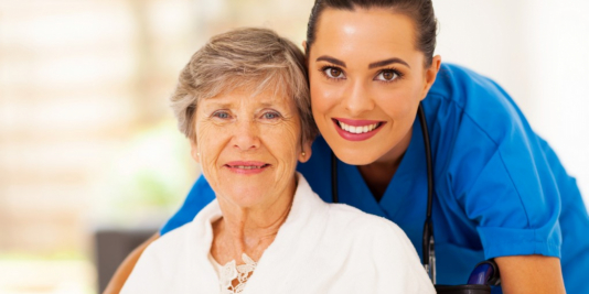 caregiver and senior woman smiling