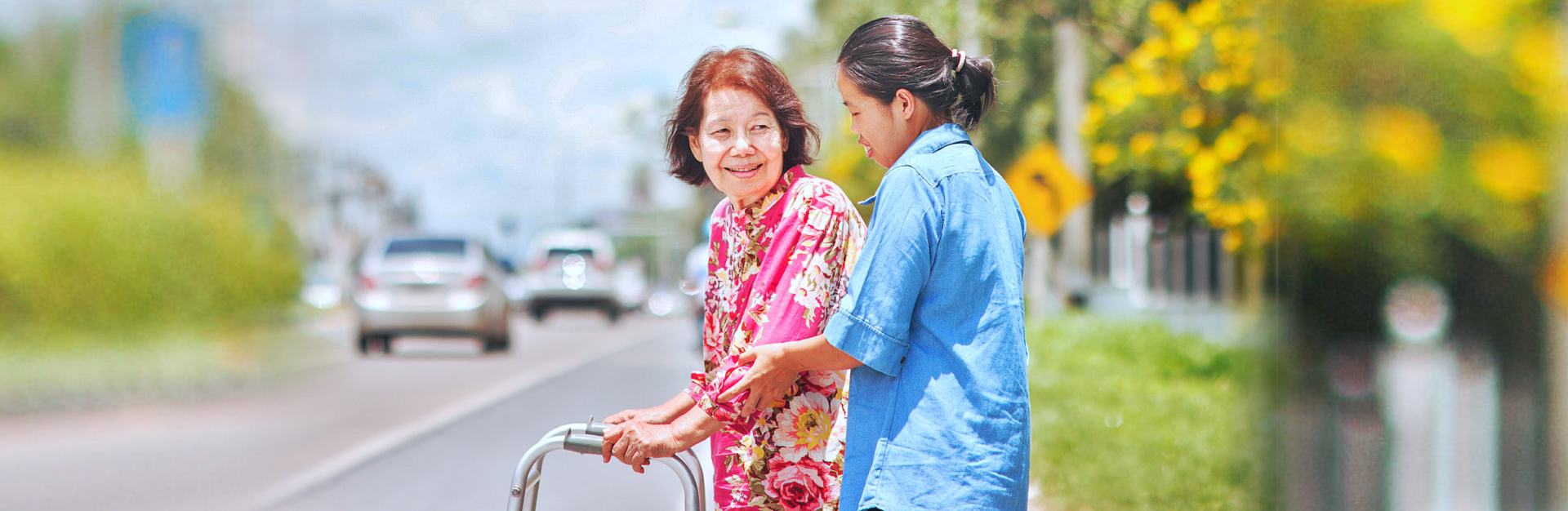 caregiver assisting senior woman in crossing the street